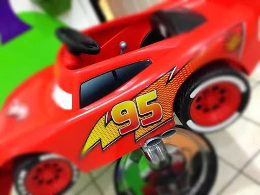 Child sitting in Fidgets' car-shaped salon chair in Whitley Bay